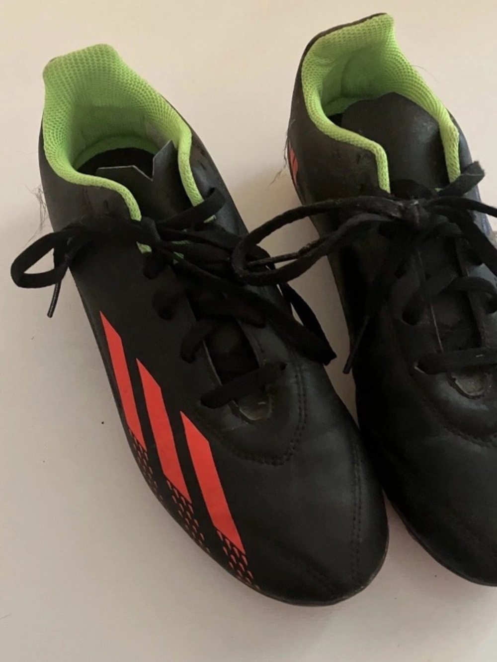 adidas Kids Black Soccer Cleats with Neon Green Lining and Orange Stripe Accents